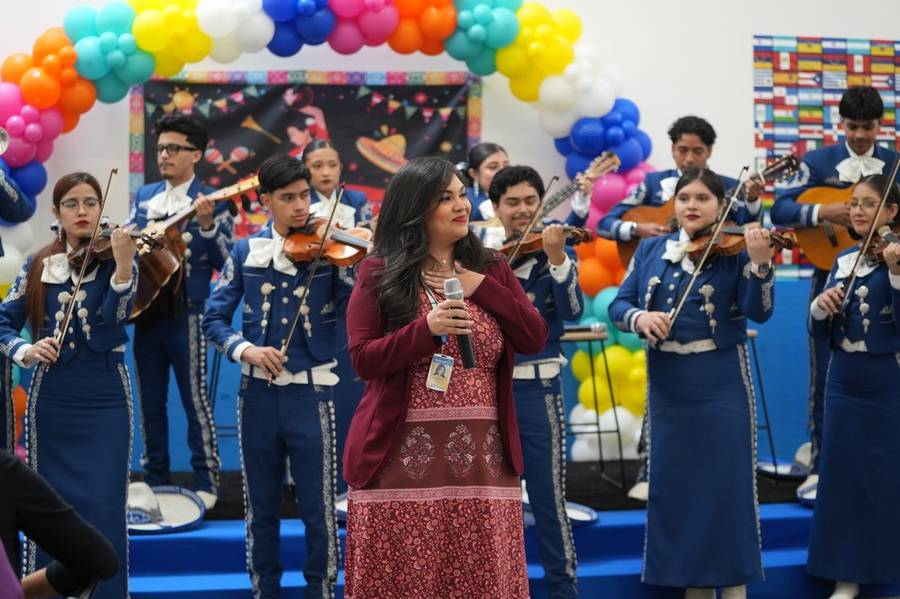 Students in mariachi dress at a community celebration in Houston